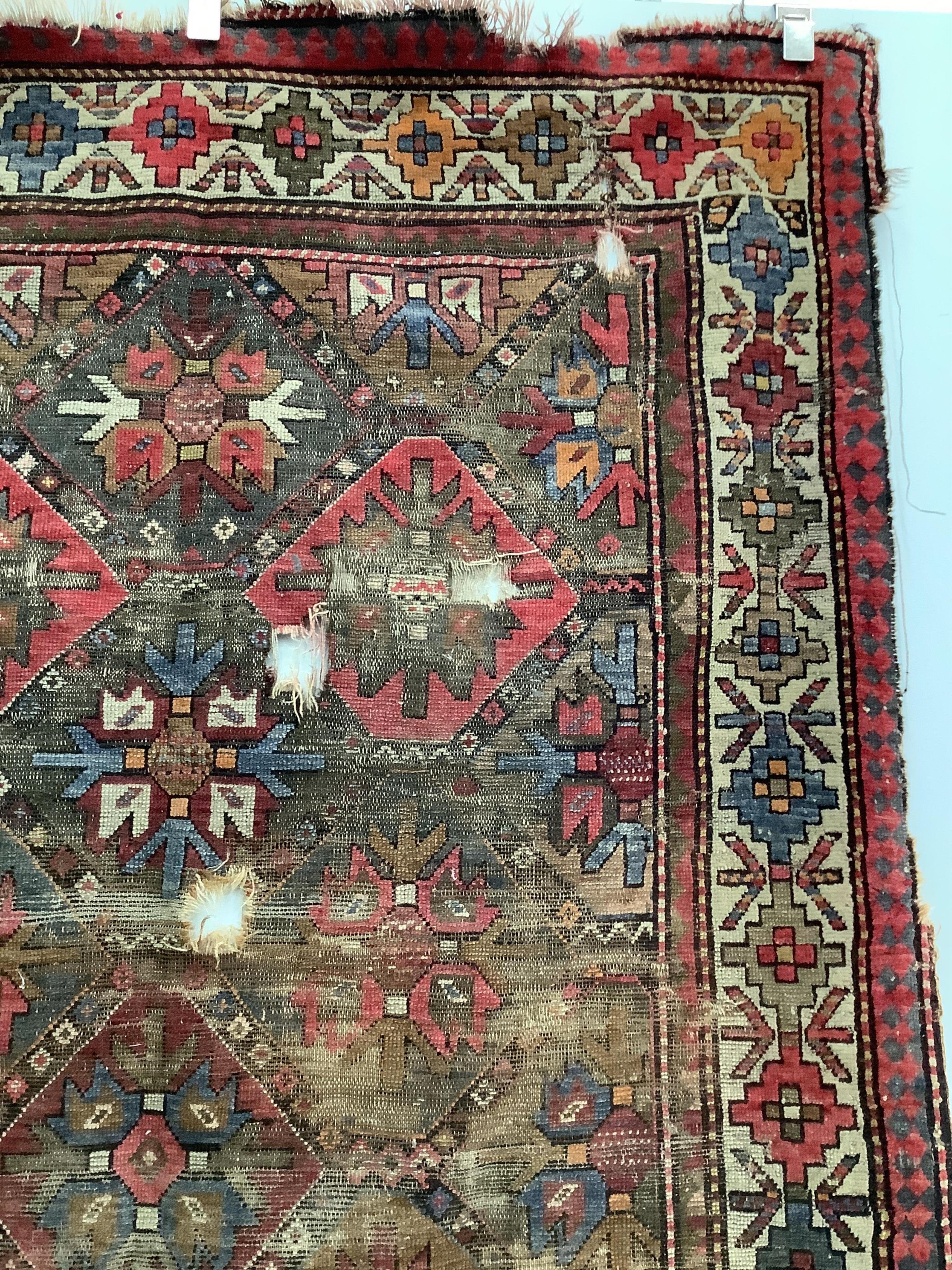 An antique Caucasian geometric rug, 250 x 140cm, together with a Belouch prayer rug, 130 x 78cm. Condition - poor